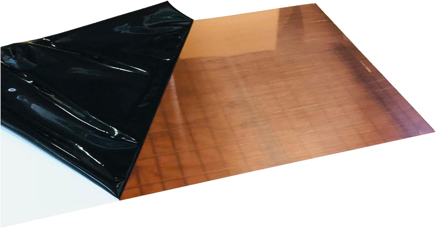 A small square of Copper Flashing with the black protective plastic film being removed.