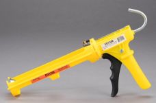 A yellow dripless caulking gun that is used to hold and apply caulk and sealant tubes.