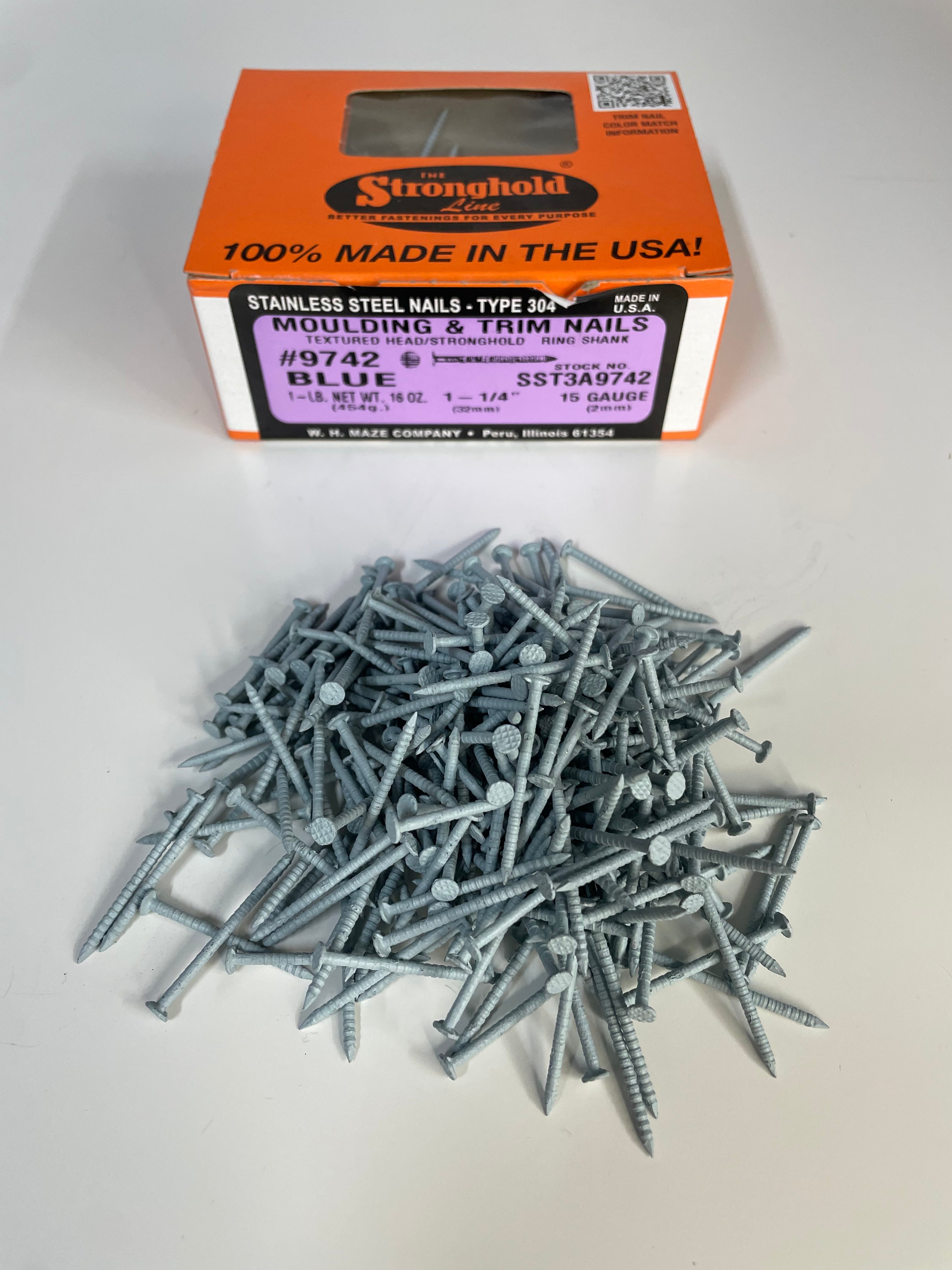 A box of Stainless Steel Trim Nails with a pile of loose nails in front of it. The nails are Polaris Blue in color.