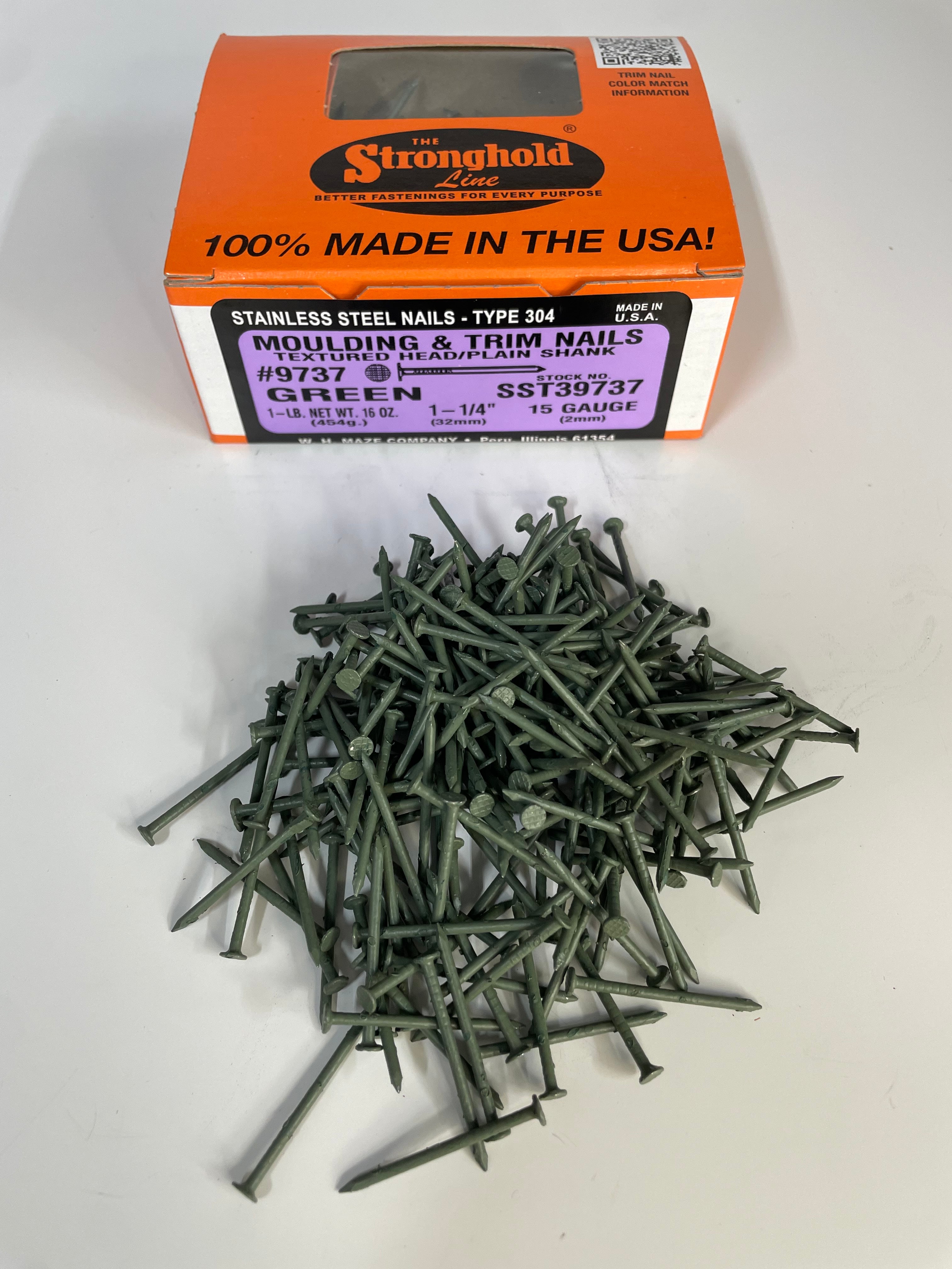 A box of Stainless Steel Trim Nails with a pile of loose nails in front of it. The nails are Spruce Green in color.