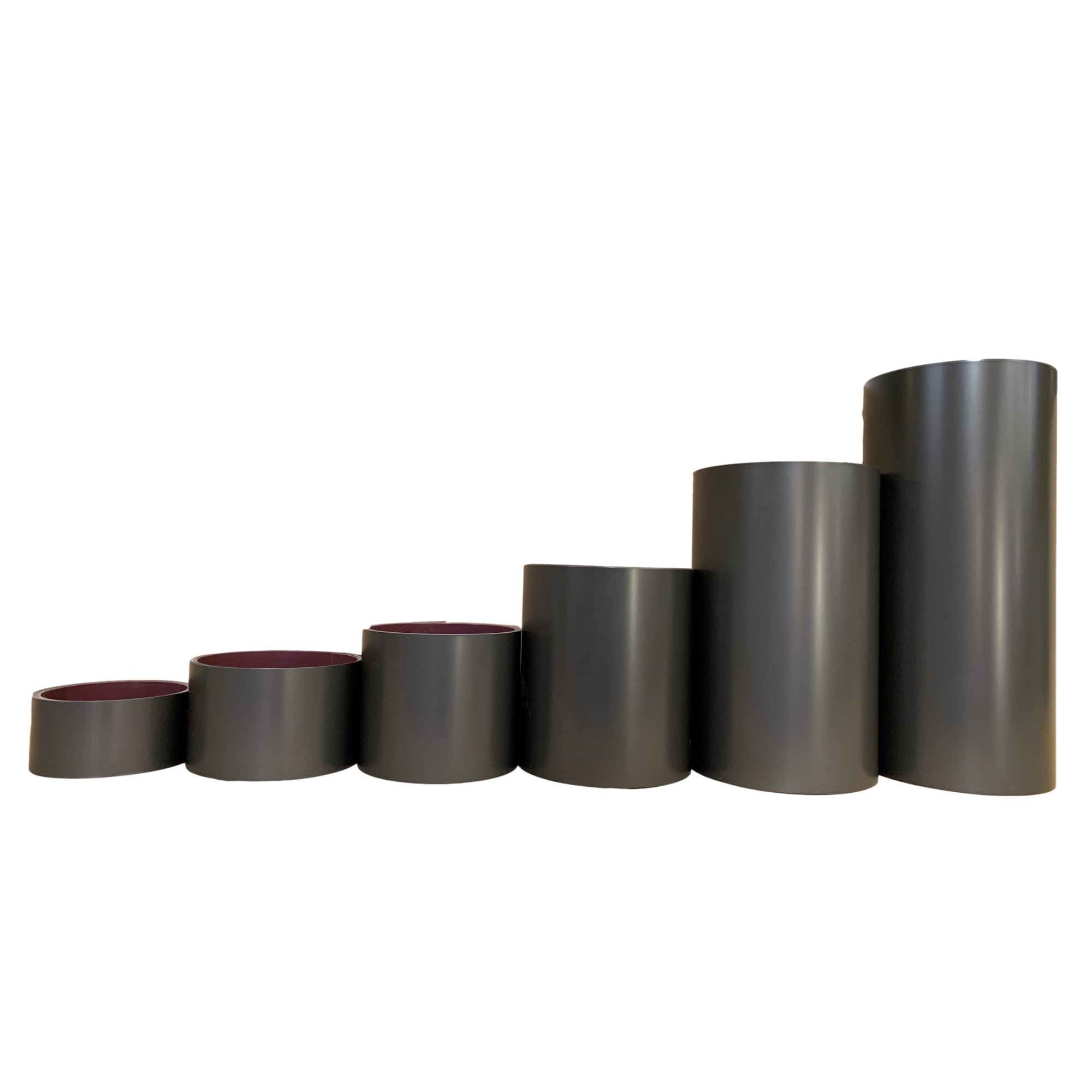 Various rolls of Smooth Aluminum Trim Coil positioned next to each other to visualize each size offered. Each roll is Dark Bronze in color.