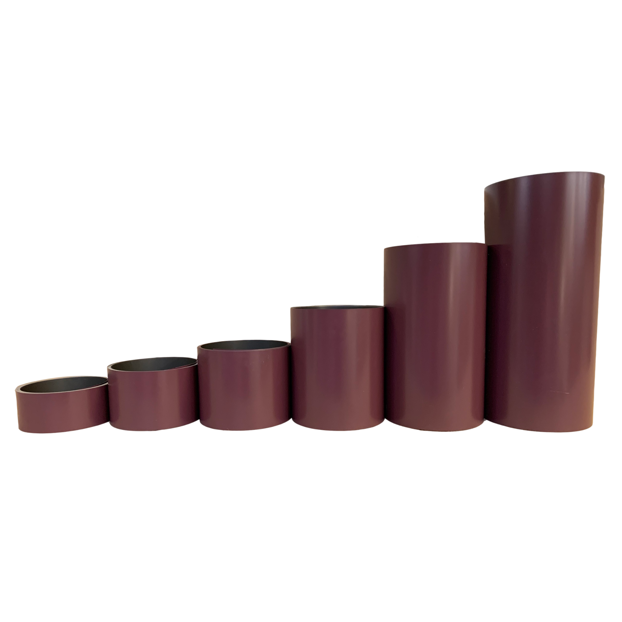 Various rolls of Smooth Aluminum Trim Coil positioned next to each other to visualize each size offered. Each roll is Burgundy in color.
