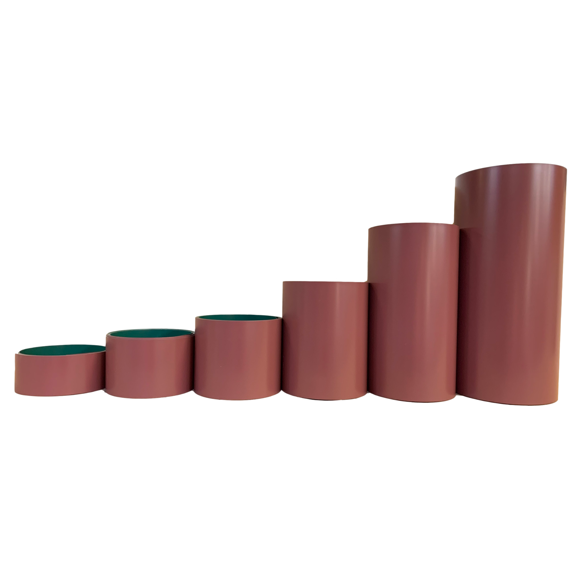 Various rolls of Smooth Aluminum Trim Coil positioned next to each other to visualize each size offered. Each roll is Rosewood in color.