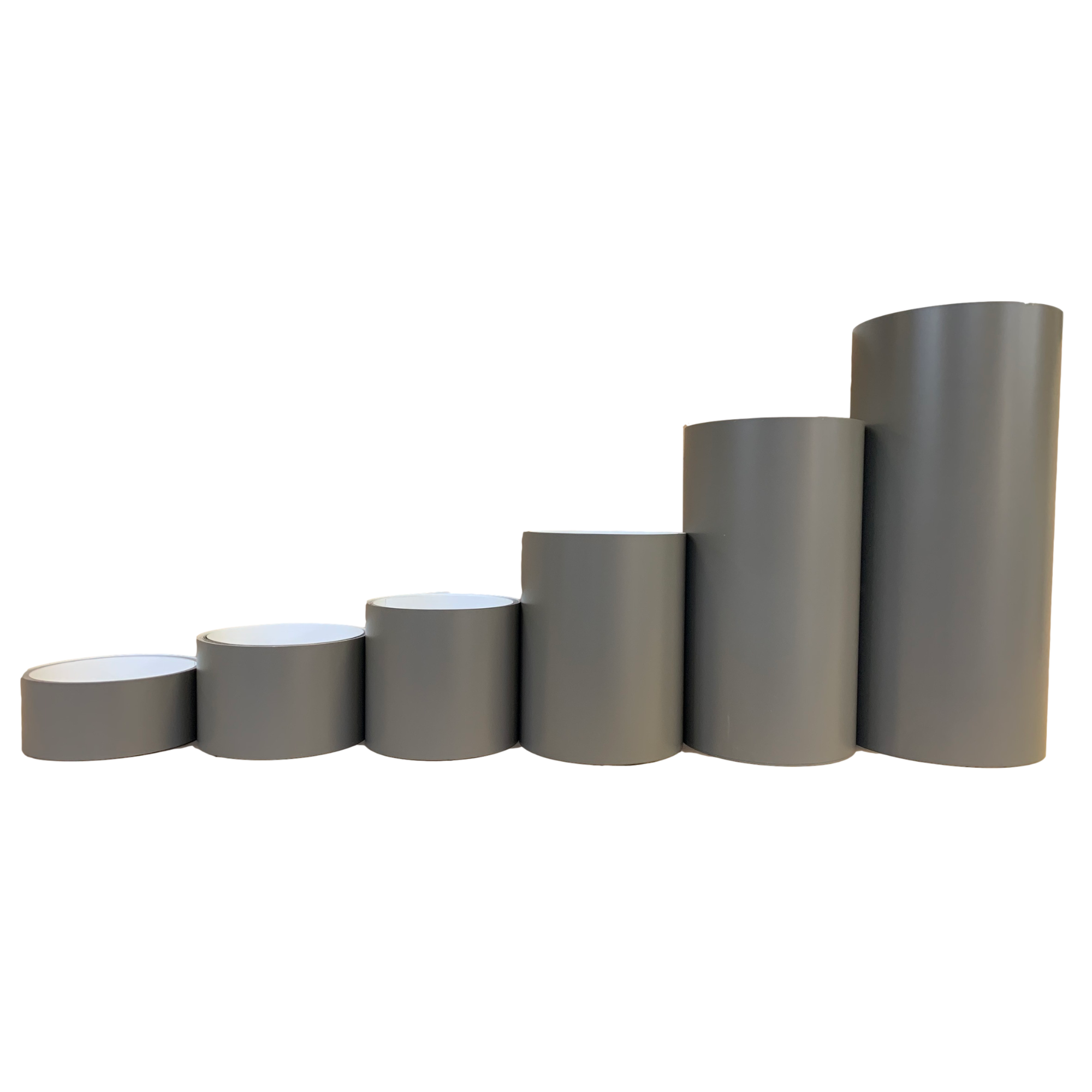 Various rolls of Smooth Aluminum Trim Coil positioned next to each other to visualize each size offered. Each roll is Light Bronze in color.