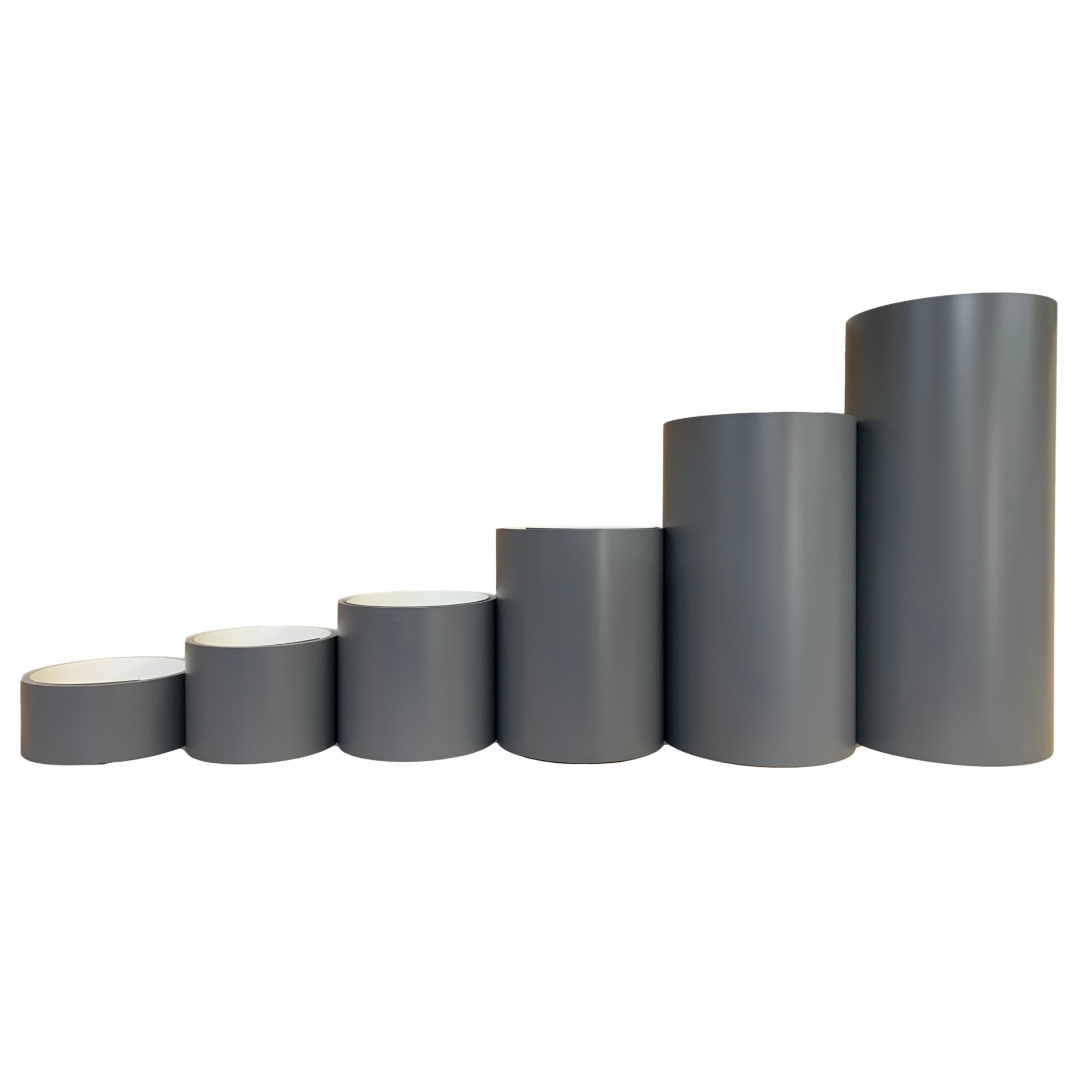 Various rolls of Smooth Aluminum Trim Coil positioned next to each other to visualize each size offered. Each roll is Tuxedo Gray in color.
