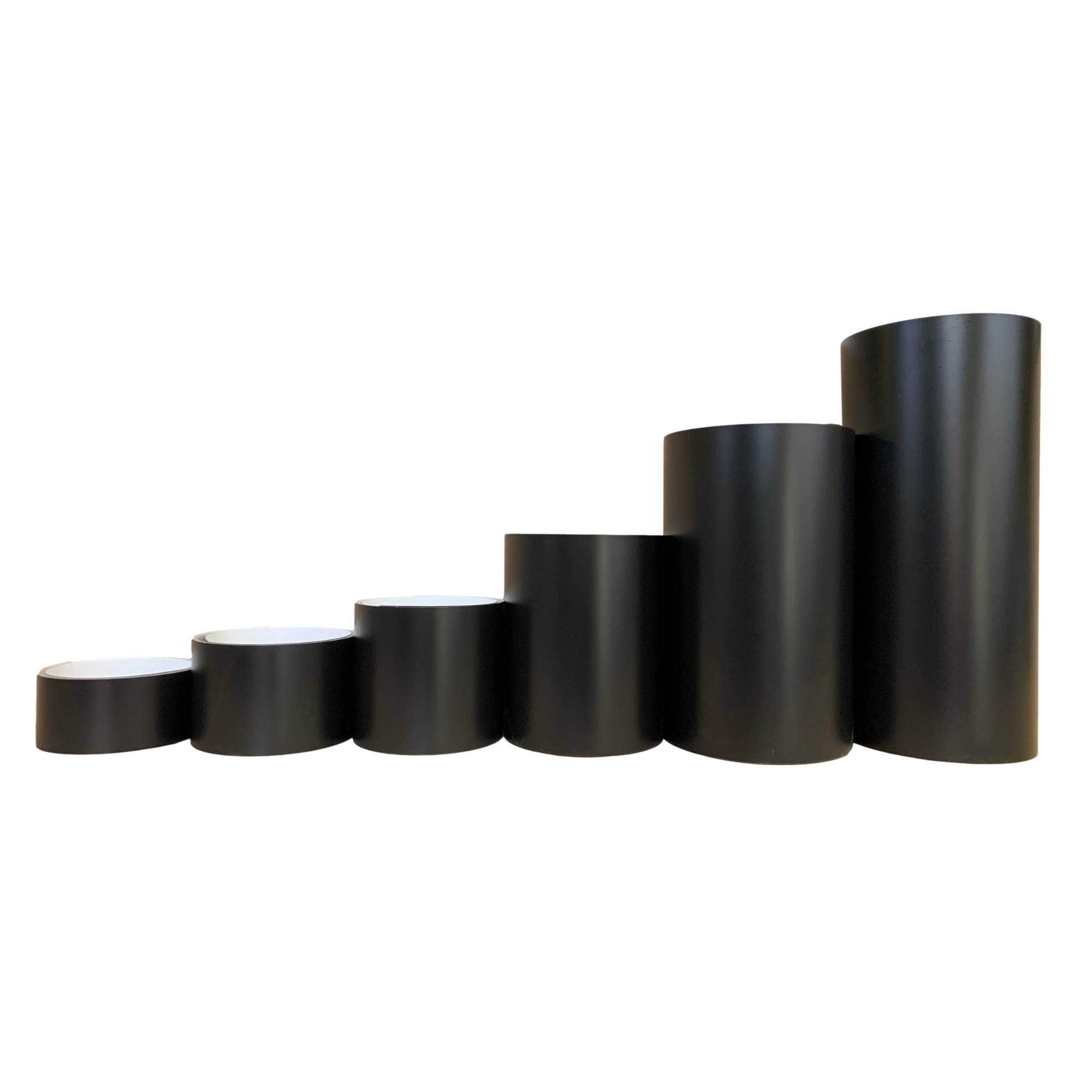 Various rolls of Smooth Aluminum Trim Coil positioned next to each other to visualize each size offered. Each roll is Black in color. 